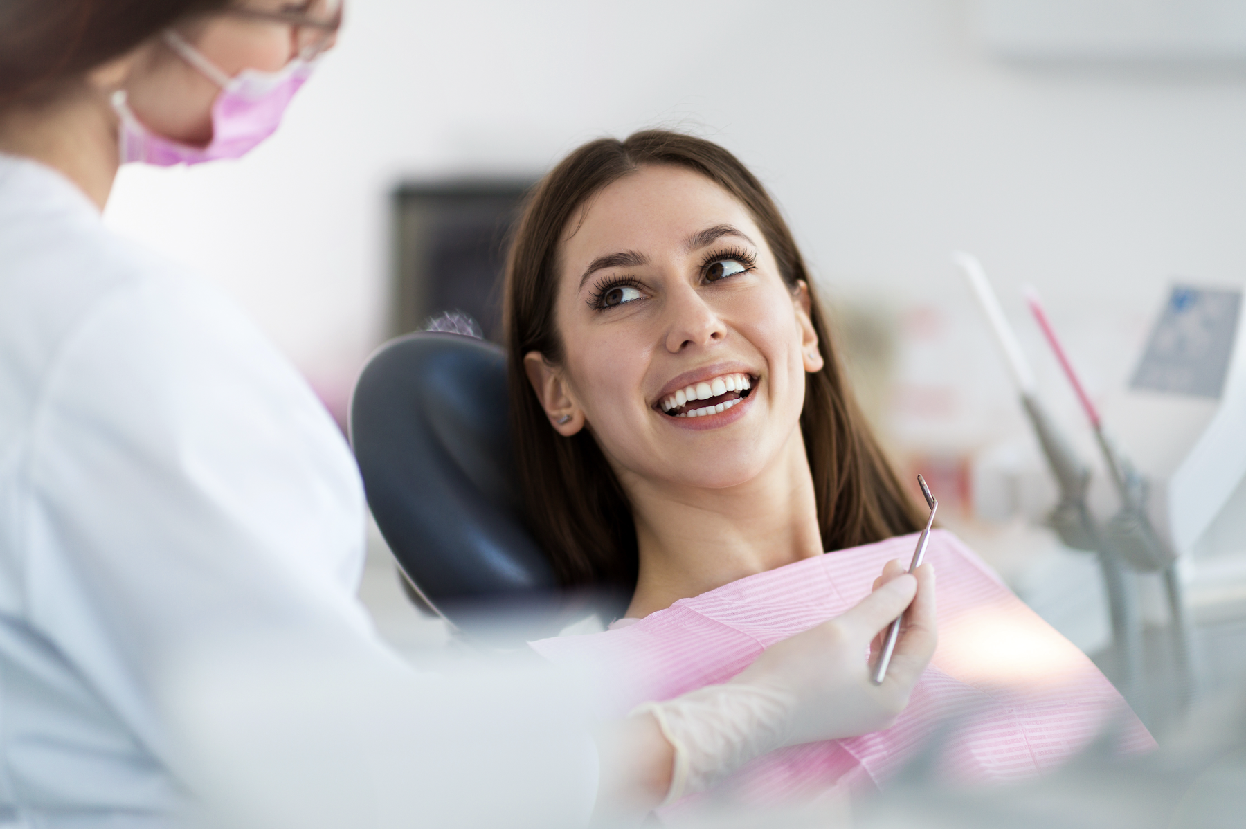Dentist consulting with a patient about a tooth extraction in Louisville, KY